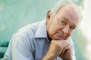 older man looking at the camera with a concerned look on his face