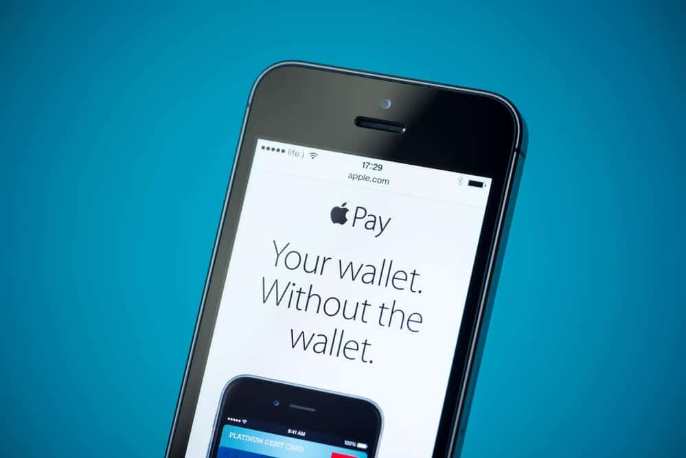 An image of a mobile phone showing an ad for Apple Pay. The ad features an Apple Pay slogan, Your Wallet Without The Wallet