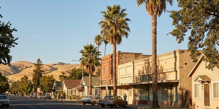 Quiet small-town main street in an affordable California town at golden hour